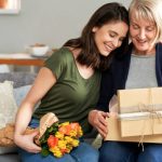 Mother and daughter unpacking a gift together